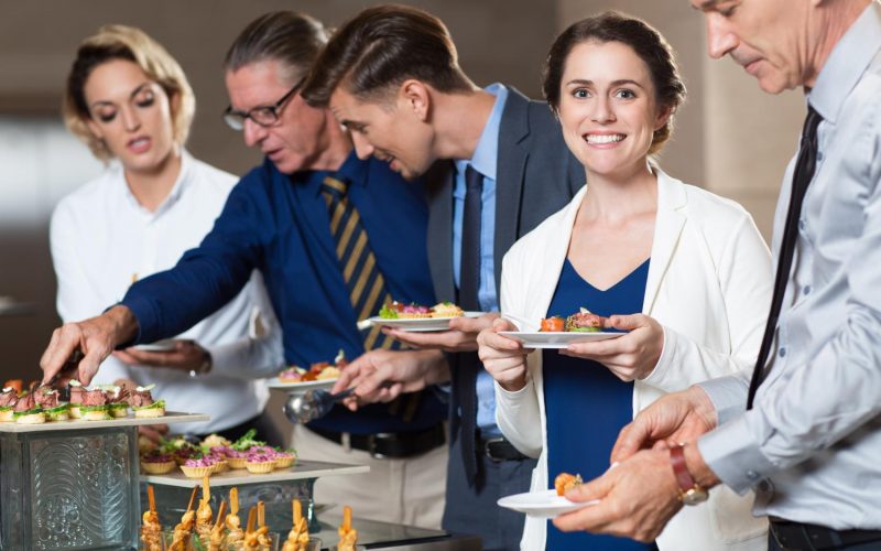 business-people-taking-snacks-from-buffet-table business-people-taking-snacks-from-buffet-table