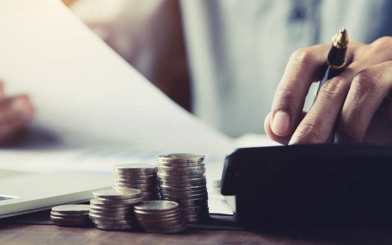 businessman-presses-calculator-with-piles-coins-stacked-into-graph-money-saving-planning-ideas
