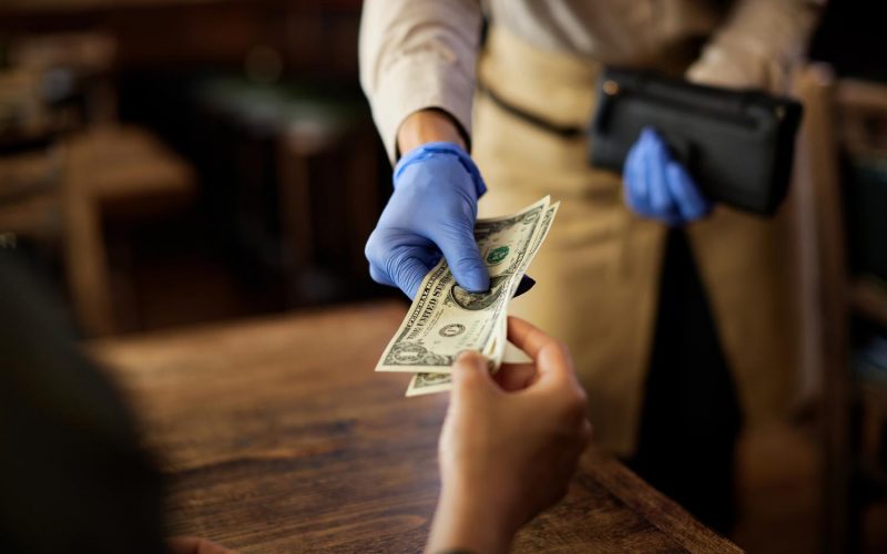 closeup-customer-paying-waitress-cafe closeup-customer-paying-waitress-cafe