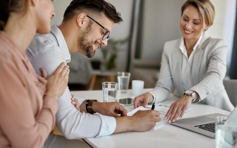 happy-man-his-wife-having-meeting-with-financial-advisor-signing-agreement-office (1)