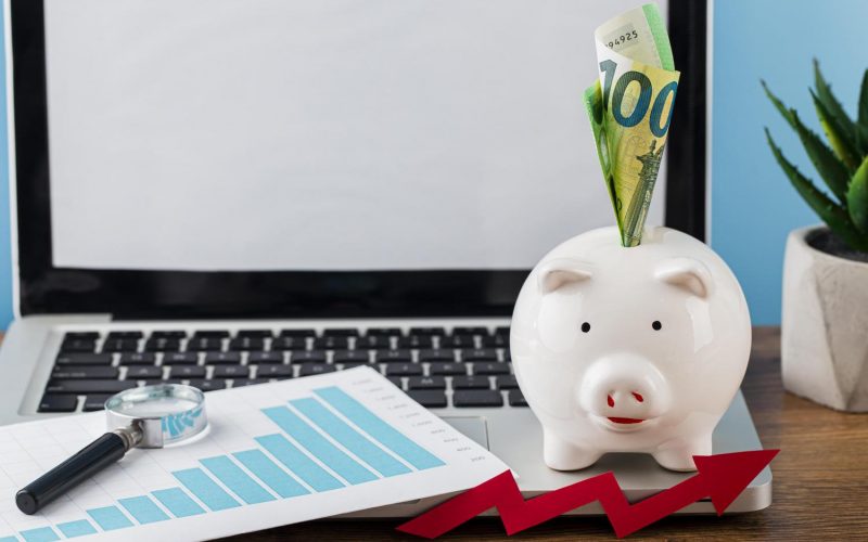 high-angle-office-items-with-piggy-bank-laptop high-angle-office-items-with-piggy-bank-laptop