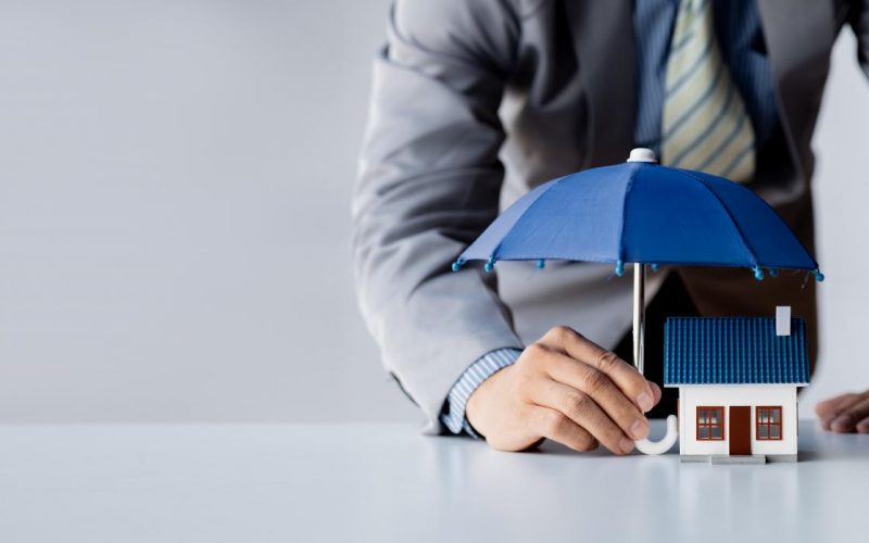 individuals-holding-small-umbrellas-model-homes-housing-insurance-against-impending-loss-fire-building-fire-insurance-home-real-estate-insurance-concepts individuals-holding-small-umbrellas-model-homes-housing-insurance-against-impending-loss-fire-building-fire-insurance-home-real-estate-insurance-concepts