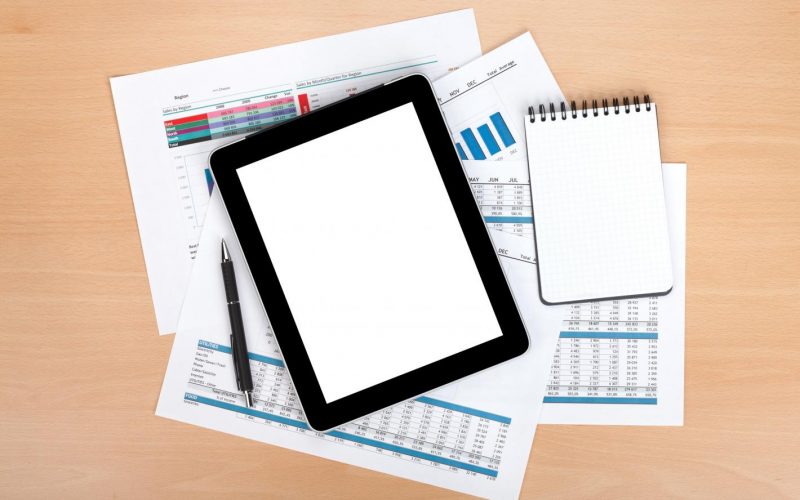 tablet-with-blank-screen-papers-with-numbers-charts tablet-with-blank-screen-papers-with-numbers-charts